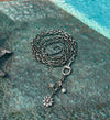 Vintage style lariat necklace with genuine pave diamond hook, horse-bit connector, flower pendant, starburst and disc charms