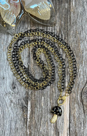 Black onyx and diamond mushroom pendant with long gold and rhodium link chains and pave diamond lobster clasp