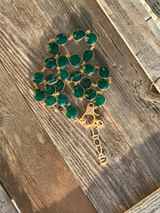 Rare emerald green onyx gemstone bezel w/ gold diamond box clasp. Gold and diamond “Love” and “XO” charms