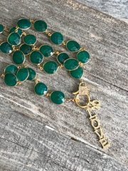 Rare emerald green onyx gemstone bezel w/ gold diamond box clasp. Gold and diamond “Love” and “XO” charms