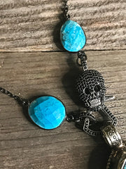 Turquoise howlite gemstone chain, black spinel skull lobster clasp.  Tibetan silver and turquoise howlite pendant.